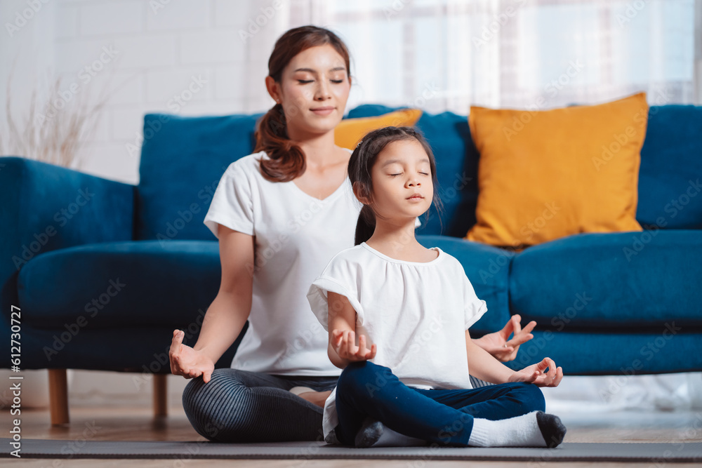 Mother and daughter exercising together happily at home. for flexibility build muscle strength, Sport workout training family together concept. Mother and daughter exercising together happily at home. for flexibility build muscle strength, Sport workout training family together concept.