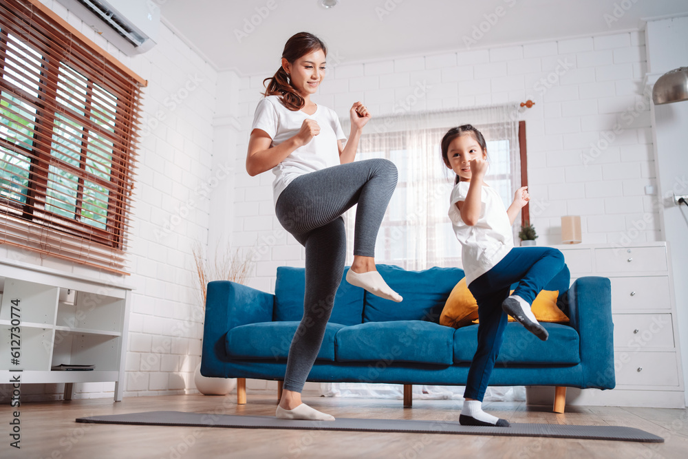 Mother and daughter exercising together happily at home. for flexibility build muscle strength, Sport workout training family together concept. Mother and daughter exercising together happily at home. for flexibility build muscle strength, Sport workout training family together concept.