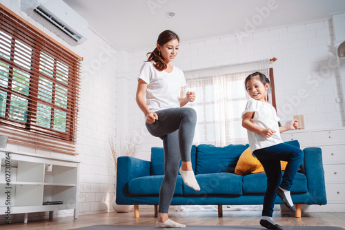 Mother and daughter exercising together happily at home. for flexibility build muscle strength, Sport workout training family together concept.