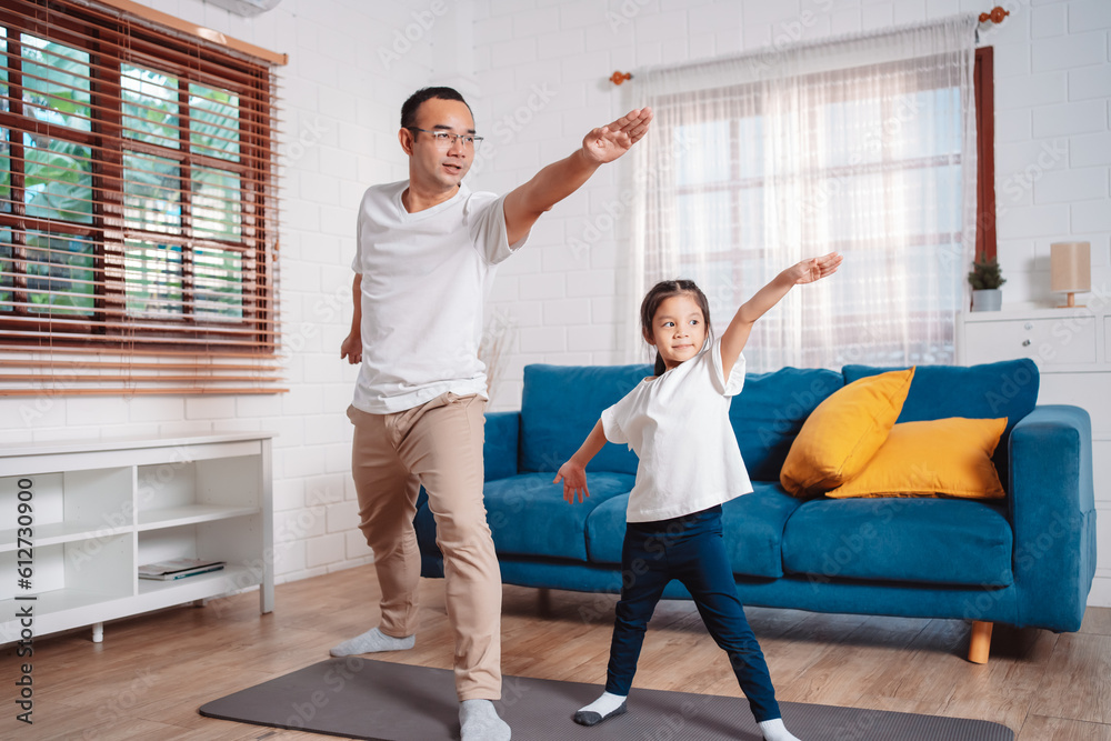 Father and daughter exercising together happily at home. for flexibility build muscle strength, Sport workout training family together concept. Father and daughter exercising together happily at home. for flexibility build muscle strength, Sport workout training family together concept.
