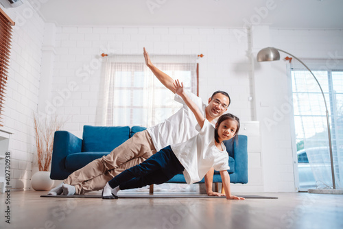 Father and daughter exercising together happily at home. for flexibility build muscle strength, Sport workout training family together concept.