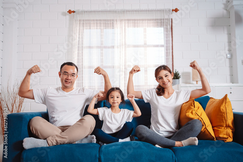 Family consisting of parents and daughters happily exercising together at home. For flexibility, build muscle strength, Sport Workout Training family together.