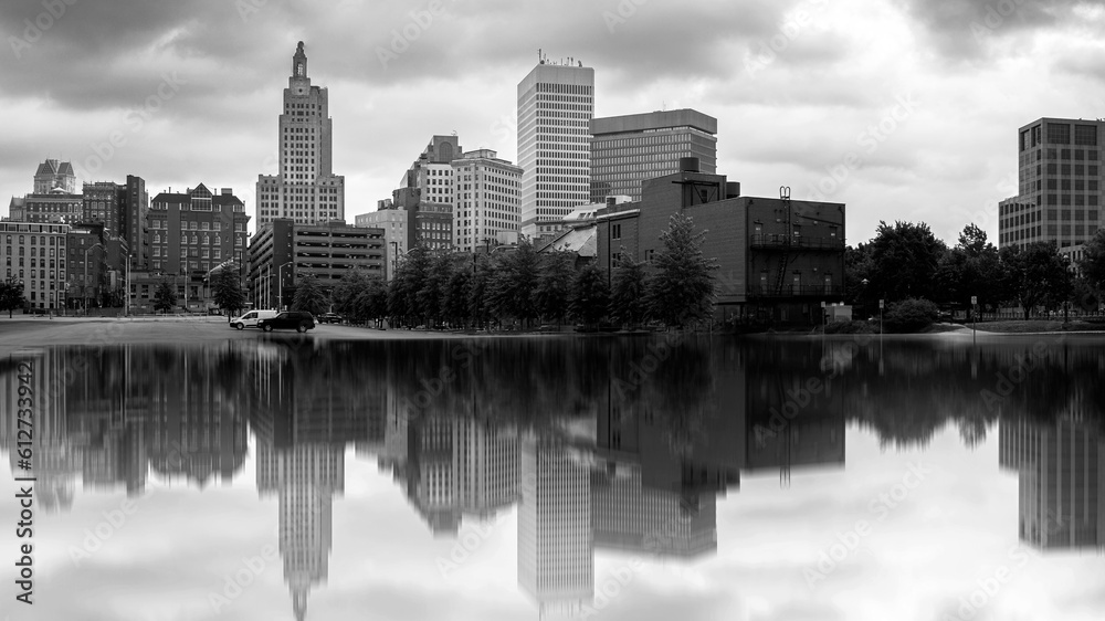 Black and white city skyline panorama. Skyscrapers, buildings, river parks, and dramatic clouds in the sky. Cityscape at Providence, the Capital of Rhode Island. 