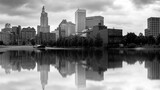 Black and white city skyline panorama. Skyscrapers, buildings, river parks, and dramatic clouds in the sky. Cityscape at Providence, the Capital of Rhode Island. 