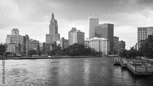 Moody black and white photo of Providence City in Rhode Island. Rainy summer day at the river park.