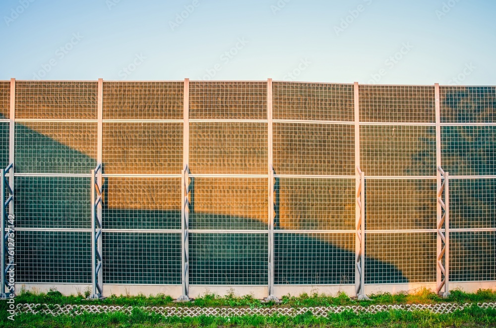Fototapeta premium Soundproof wall by the roadside. Soundproofing wall of the high-speed road.
