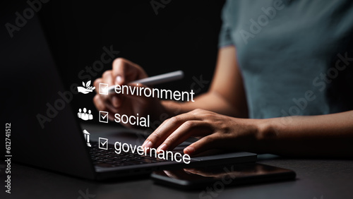Concepts of ESG, environment, society and governance. Energy of a sustainable natural gas business Businessman using computer to analyze investment concept Business strategy for society, environment