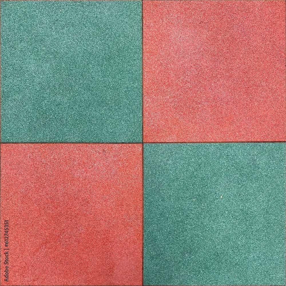 Fototapeta premium Colorful rubber tile on playground floor at the yard in the park. Children's playground in the park with soft floors.