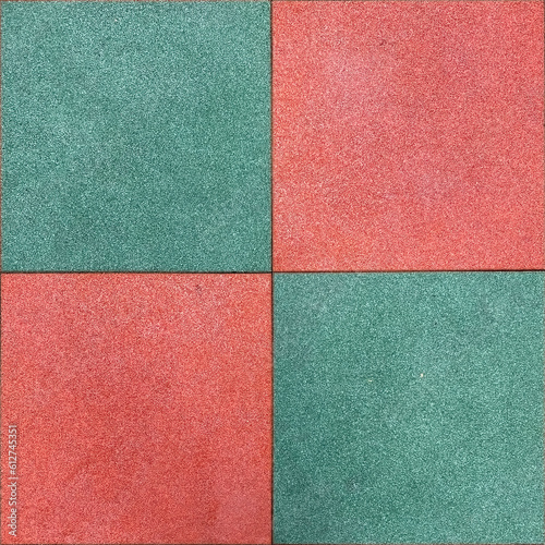 Colorful rubber tile on playground floor at the yard in the park. Children's playground in the park with soft floors.
