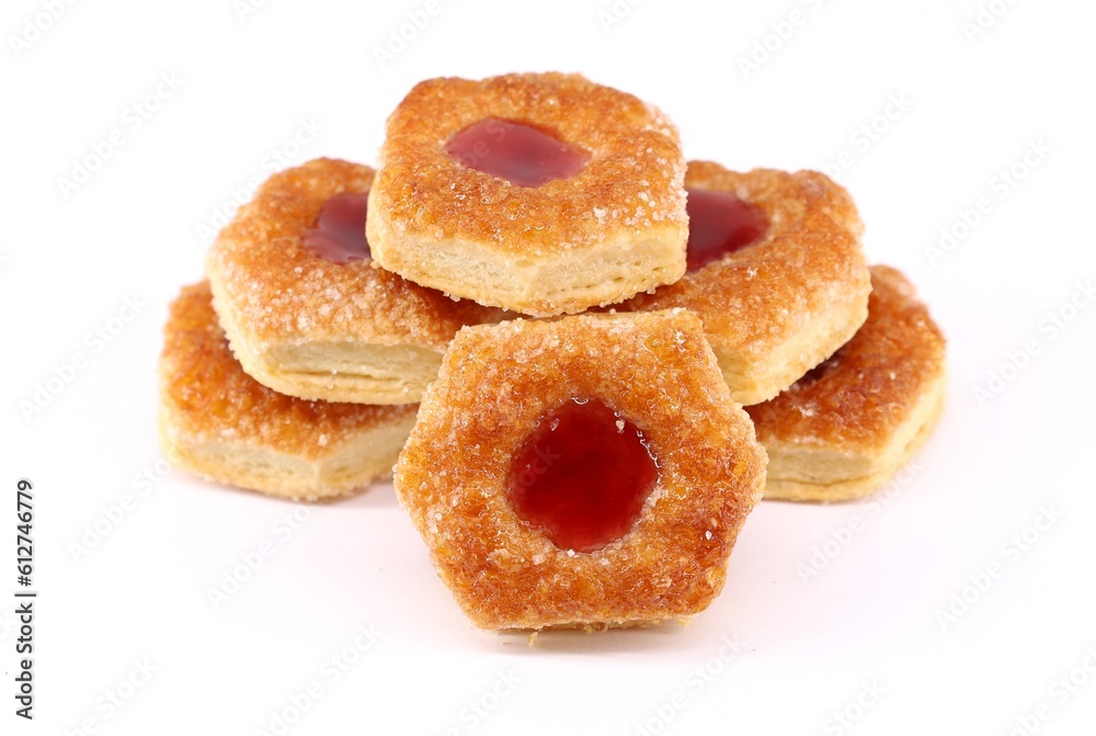 Small puff pastry cookies stuffed with berries jam on a white background
