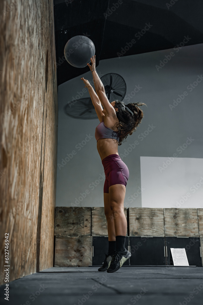 Woman training with a weighted ball