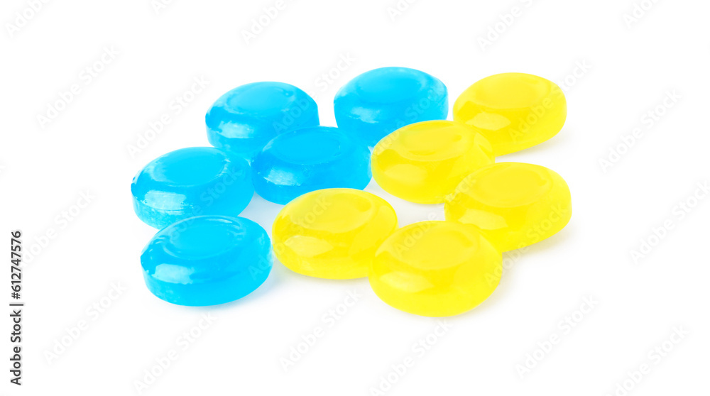 Many colorful cough drops on white background