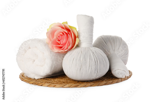 Beautiful spa composition with rolled towel, flower and herbal bags on white background
