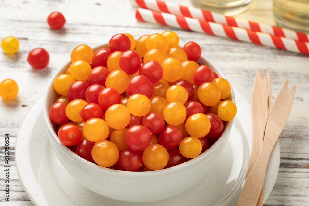 Bowl with fresh red and yellow Tomberry tomatoes close up Bowl with fresh red and yellow Tomberry tomatoes close up