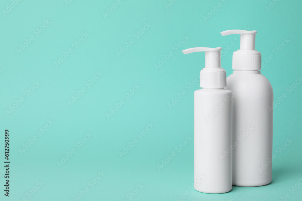 Different cleansers on turquoise background, space for text. Cosmetic product Different cleansers on turquoise background, space for text. Cosmetic product