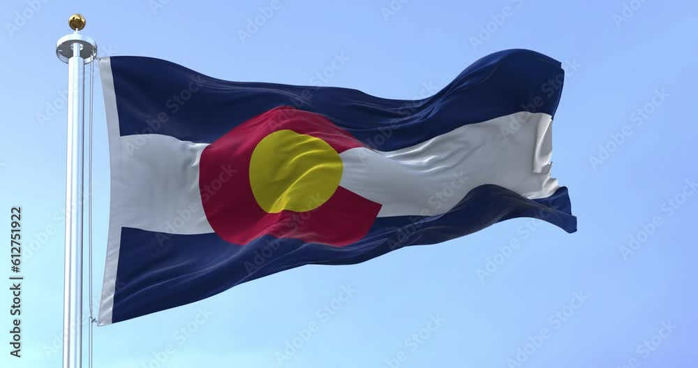 Seamless loop in slow motion of Colorado state flag waving on a clear day