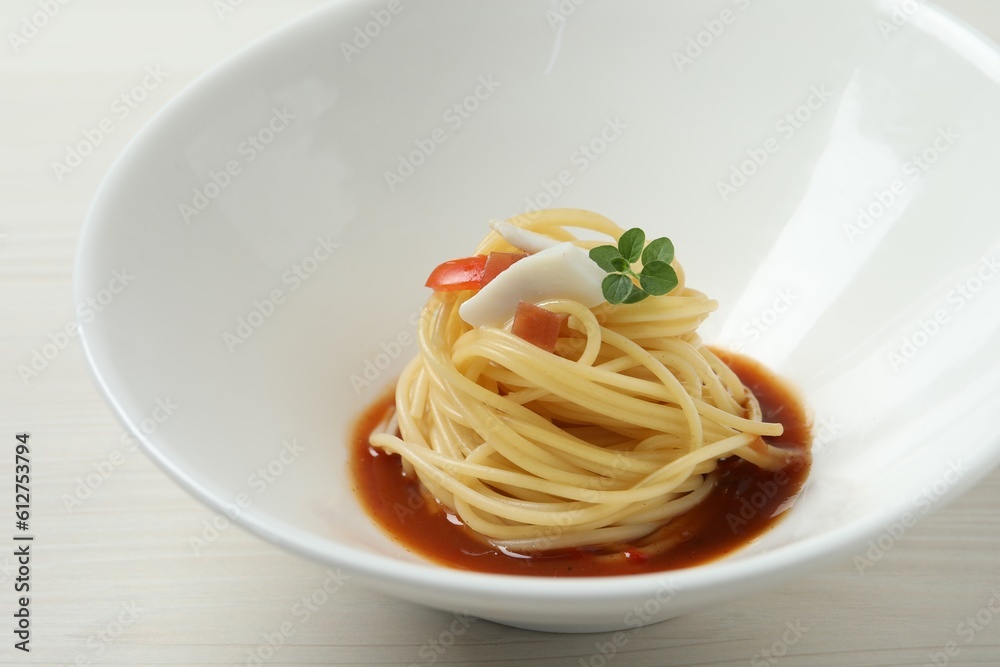 Tasty spaghetti with sauce on white wooden table, closeup. Exquisite presentation of pasta dish Tasty spaghetti with sauce on white wooden table, closeup. Exquisite presentation of pasta dish