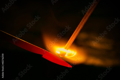 Burn the match up by the hot iron stick.