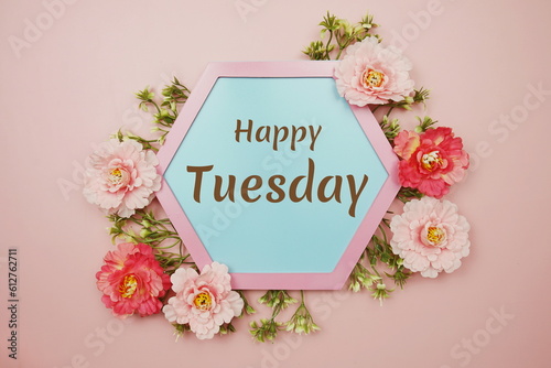 Happy Tuesday typography text decorate with flower on pink background