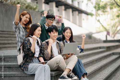 Wallpaper Mural Asian Students are studying the campus park. Young people are spending time together. Reading book, working with laptop and tablet sitting on stairs Torontodigital.ca