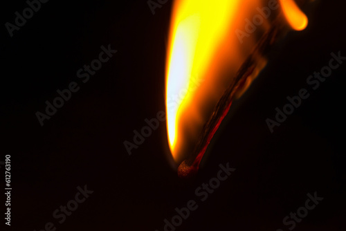 Burning match in the dark. Close up view.