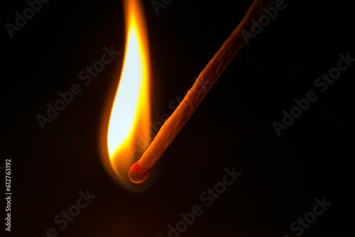 Burning match in the dark. Close up view.