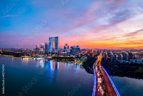 Aerial view of city skyline and modern buildings in Suzhou at sunset, Jiangsu Province, China. Famous urban skyline by the lake.