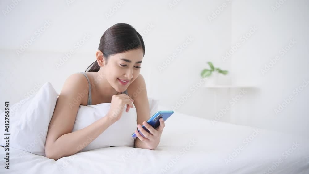 Holiday concept of 4k Resolution. Asian girls playing cell phones in the bedroom. social network. Internet communication. Holiday concept of 4k Resolution. Asian girls playing cell phones in the bedroom. social network. Internet communication.