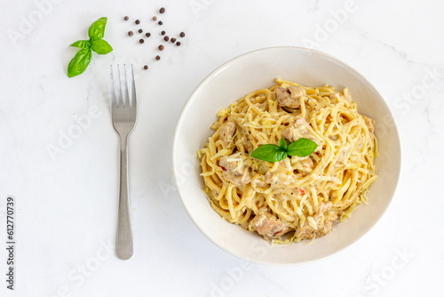 Chicken Spaghetti with Basil Leaves Top Down Italian Food on White Background