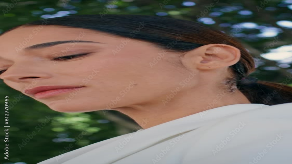 Rich business lady looking around standing at park vertically oriented closeup Rich business lady looking around standing at park vertically oriented closeup