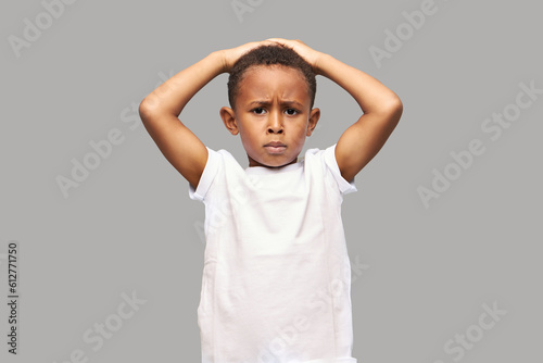 Fotografía Upset disappointed kid boy in white mockup t-shirt with copy space for your prom