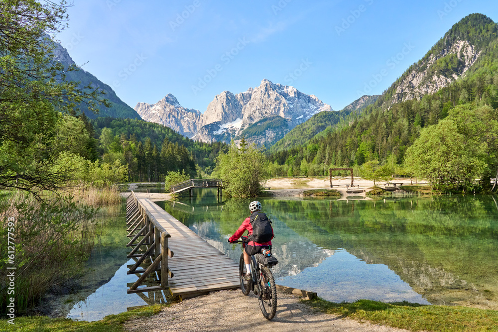 active senior woman on a mountain bike tour at Lake Jezero Jasna in the Triglav National Park near Kranska Gora, Julian Alps, Slovenia