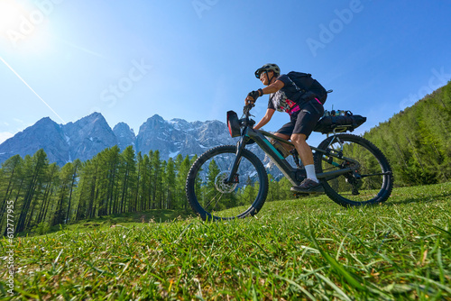 active senior woman on a mountain bike tour in the Julian Alps above Kranska Gora in Slovenia
