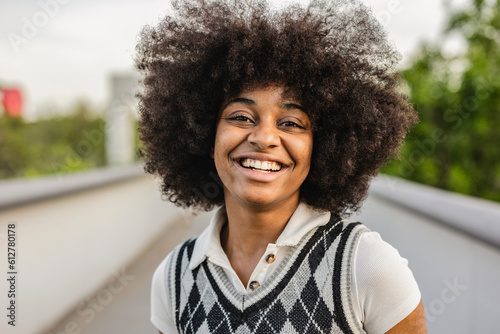 portrait of pretty african american woman smiling outdoors © PintoArt