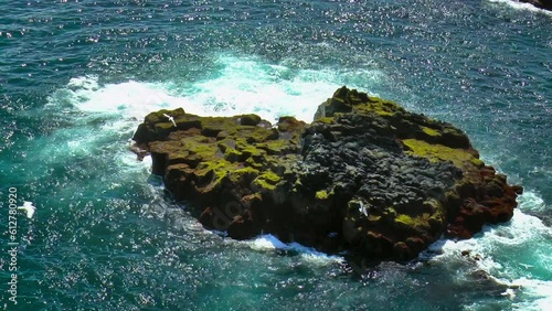 Slow motion footage of sea waves on coast line with cliffs and rocks in Arnarstapi village in Iceland on Snaefellsnes peninsula. photo