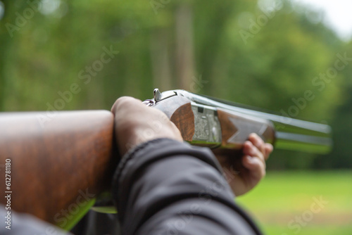 Skeet Shooting .Man shooting at target on an outdoor shooting range at sunny day, training alone, confident and skilled, experienced. Shooting and Guns.