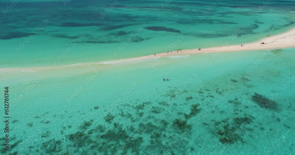 Drone pan right tropical sandbar, people walking along white sand, sea water texture Drone pan right tropical sandbar, people walking along white sand, sea water texture