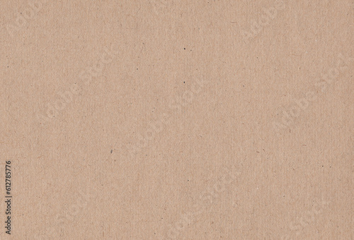 Textured light brown coloured natural cardboard material background. Extra large highly detailed image of empty carton paper image.