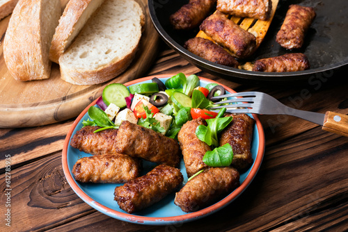 Traditional greek meatballs,bifteki with salad on a blue plate