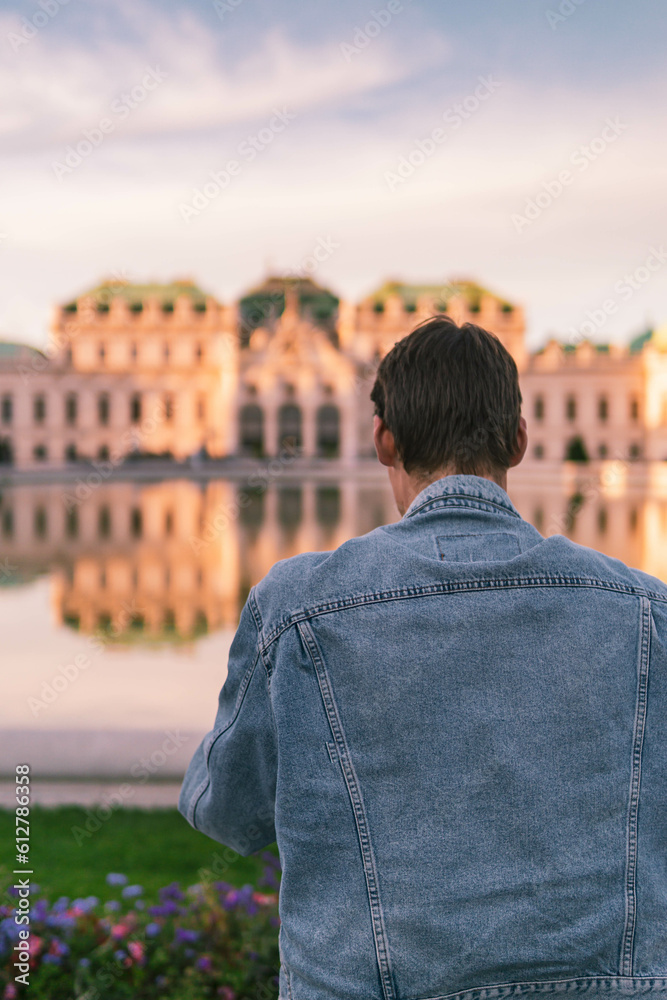 Man in front of Belvedere palace in Vienna at sunset Man in front of Belvedere palace in Vienna at sunset