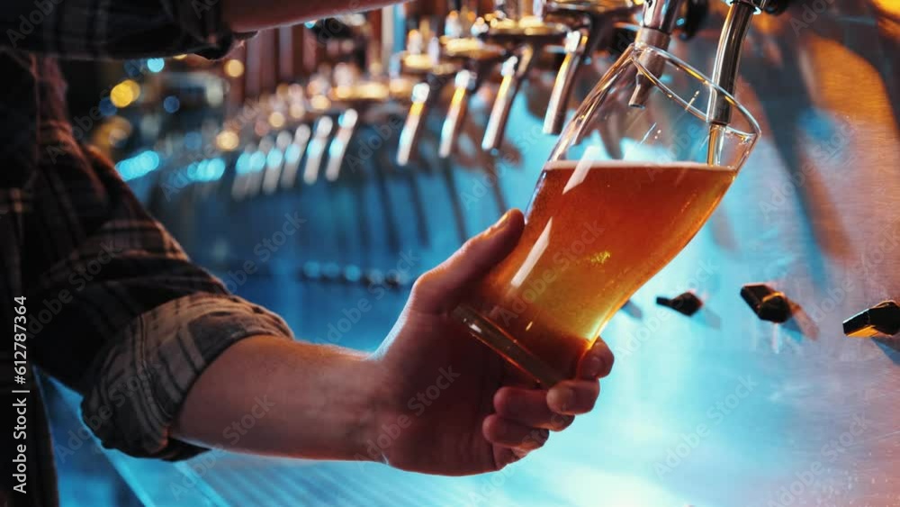 Close-up pf male hand of bartender pouring a large glass of lager beer with tap. Pouring beer for client at pub, bar. Concept of alcohol drink, party, taste, relaxation. Ad