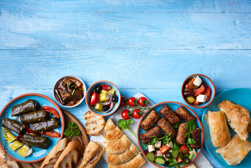 Traditional greek food on a blue wooden background.Copy space
