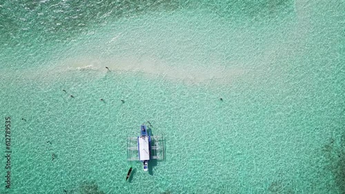 Top down perspective overview of banca outrigger boat in balabac sandbar water photo