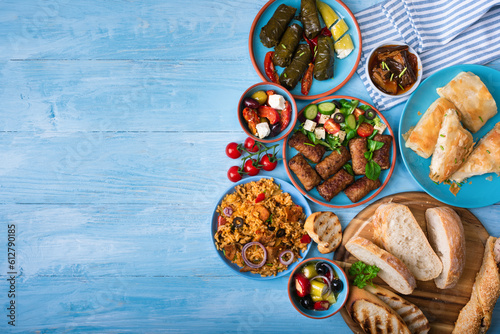 Various Greek dishes on a blue wooden background.Copy space