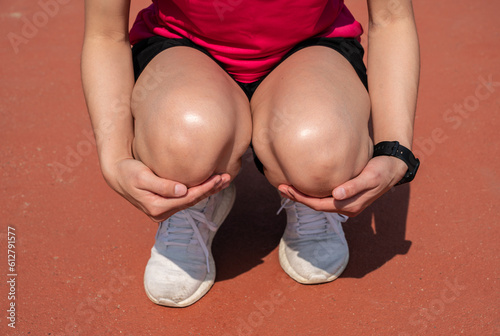 Εκτύπωση καμβά Cropped shot of female runner kneel down, suffering from knee pain