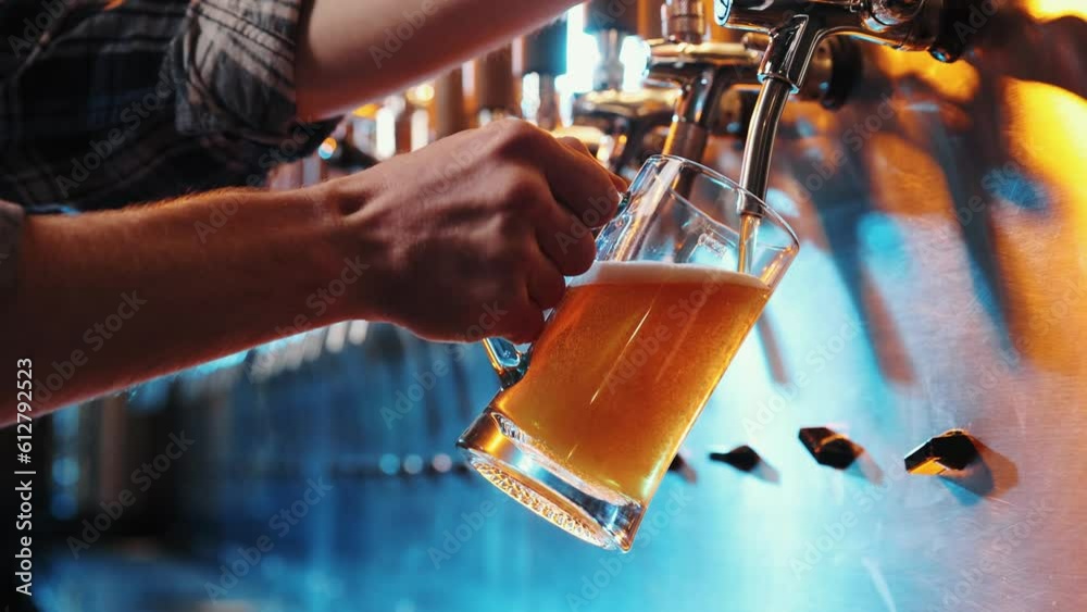 Close-up pf male hand of bartender pouring a large glass of lager beer with tap. Pouring beer for client at pub, bar. Beer degustation. Concept of alcohol drink, party, taste, relaxation. Ad
