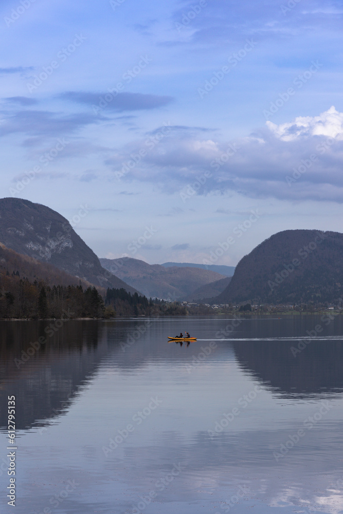 Sunset reflections at Lake Bohinj with a canoe in the foreground. Sunset reflections at Lake Bohinj with a canoe in the foreground.