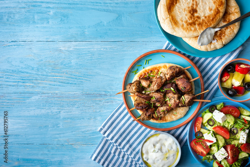 Greek souvlaki with pita bread, tzatziki sauce and salad.Copy space 