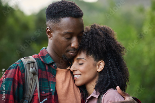 Loving young multiethnic couple hugging during a break from a hike