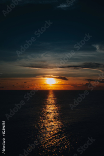 Bright orange sunset on the dark Indian Ocean on Bali island. Evening sunlight  fire sky  amazing view